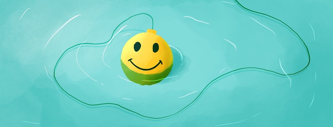 a yellow fishing bobber with a smiley face floating in the water