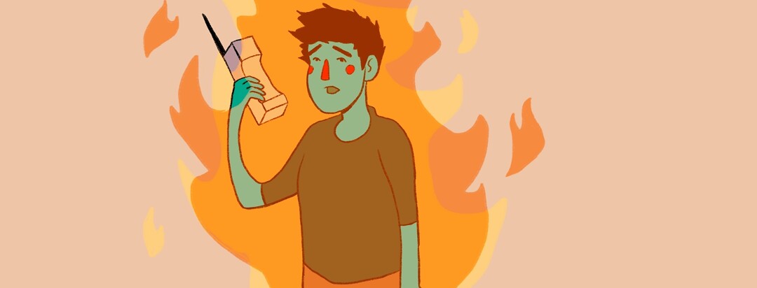 anxious person holding a phone while on fire