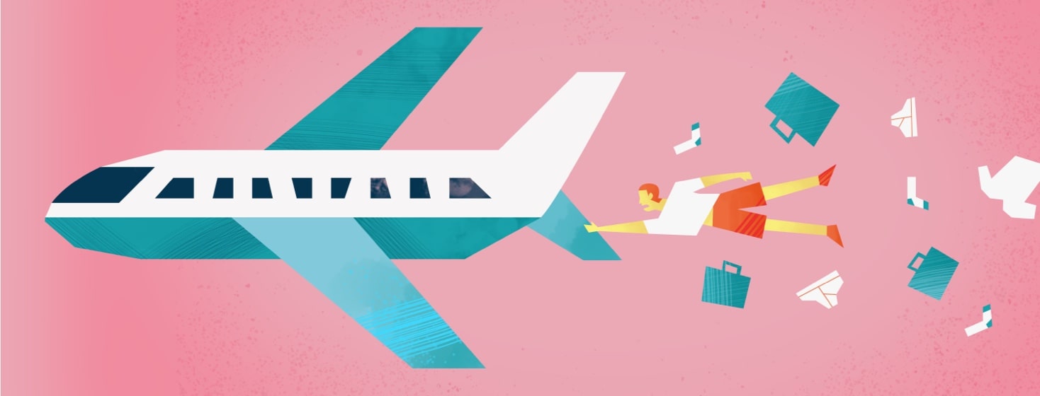 a man holding on to the back of a plane while his luggage flies out