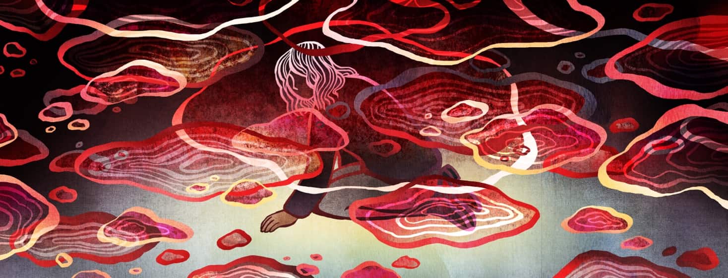 A woman crouches in despair, her face and body obscured by masses of red blobs